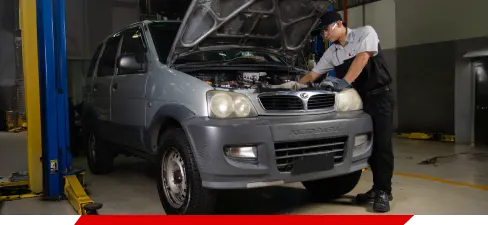 Perodua footwell and pedals shown for driving position context.
